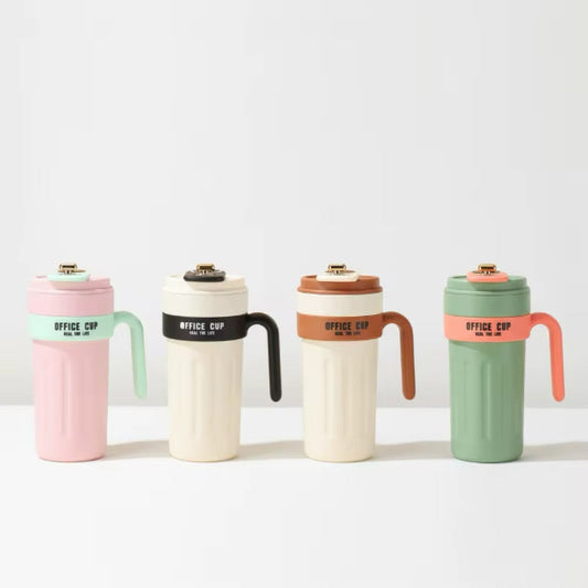 Four insulated office cups with handles and lids, shown in pastel pink, cream, cream-brown, and sage green. Each cup has a colored band with the text 'OFFICE CUP' and a small gold metal detail on the lid, arranged on a white surface against a light gray background.