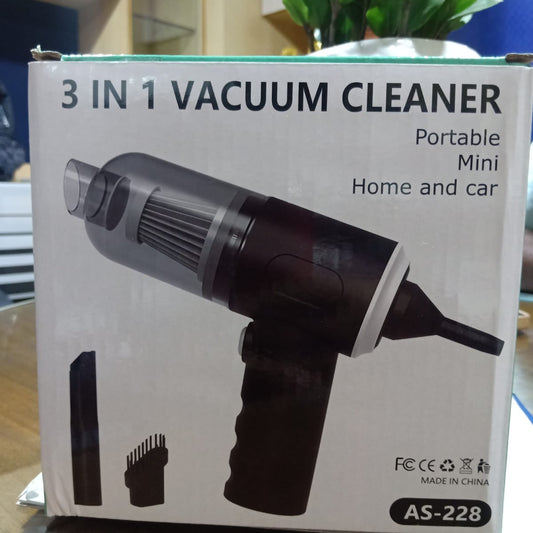 Box of a 3-in-1 vacuum cleaner on a table with a plant in the background