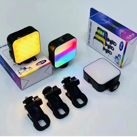 A 3-in-1 LED pocket bike light set displayed with its packaging and accessories on a light gray background. The set includes a square light with a yellow light, a square light with a rainbow light, a rectangular light with a white panel, three black mounting clips, and two product boxes.