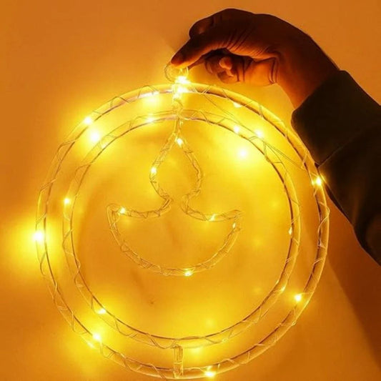 Warm white LED string lights shaped like a crescent moon and teardrop, with a hand turning on the light fixture against a glowing yellow background.